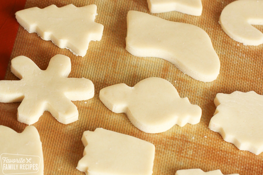 Sugar cookie dough cut into Christmas shapes