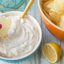 Dipping a chip into a bowl of clam dip