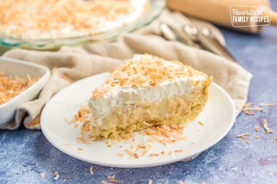 A slice of coconut cream pie with toasted coconut sprinkles