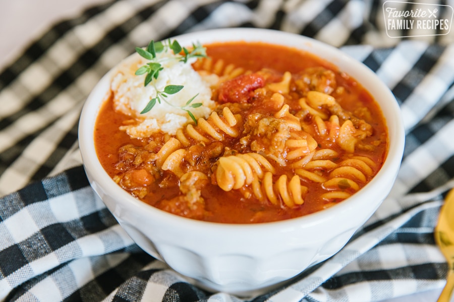 Lasagna soup with cheese topping in a serving bowl