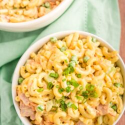 Macaroni salad in a white bowl with a green napkin