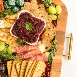 Part of a Christmas Charcuterie Board on a wooden try with gold handles