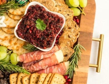 Part of a Christmas Charcuterie Board on a wooden try with gold handles