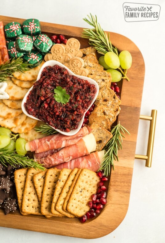 Part of a Christmas Charcuterie Board on a wooden try with gold handles