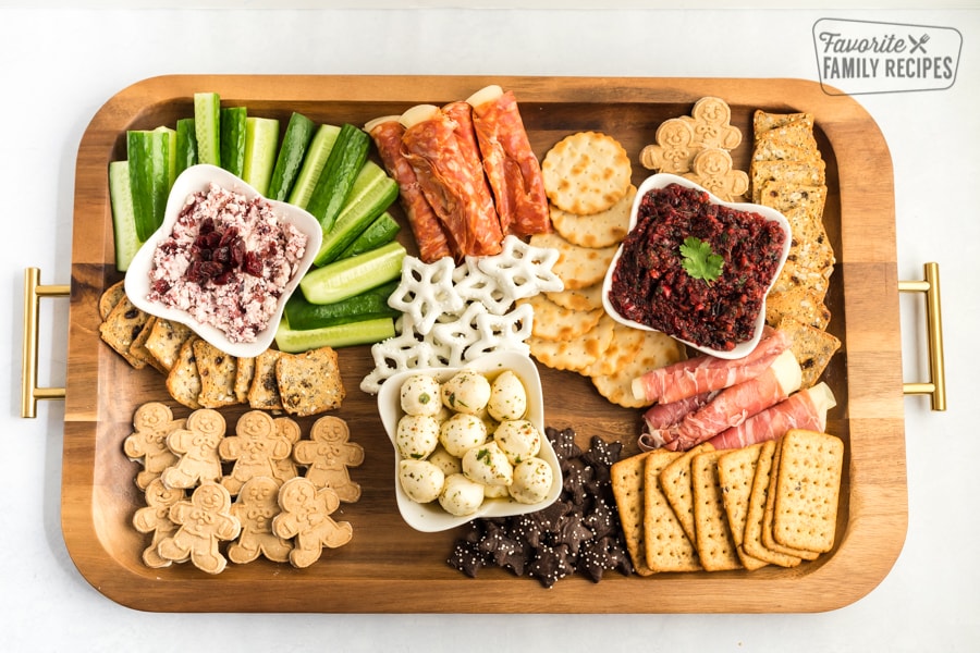All the larger crackers, meats, and cheeses placed on a charcuterie board