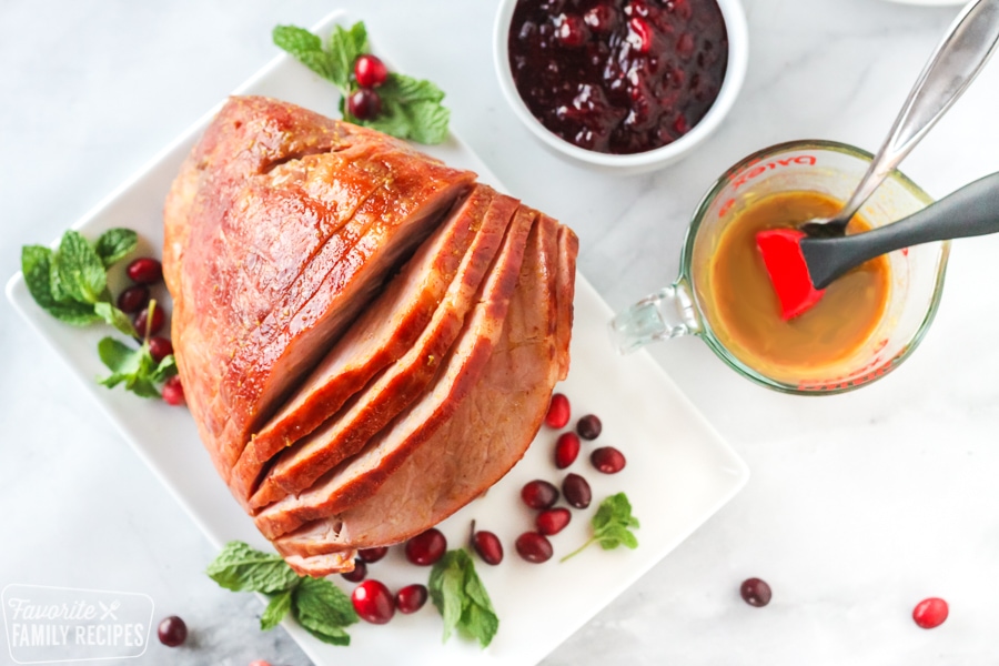 Large ham with cider glaze and cranberries.