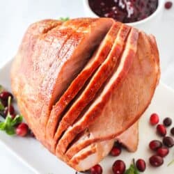 Half of a cooked ham on a serving plate