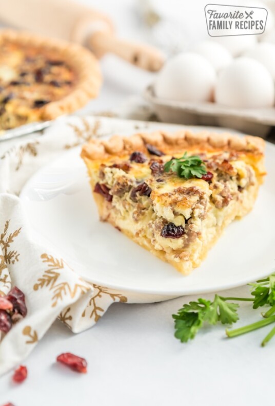 A slice of Christmas Breakfast Quiche on a white plate