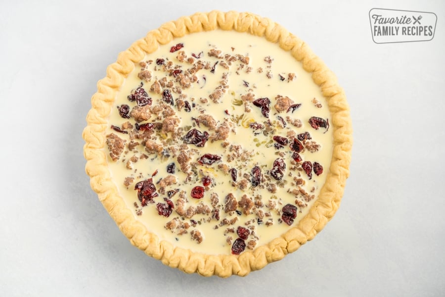 A raw Christmas quiche ready to cook in the oven.