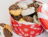 A Christmas tin filled with dipped ritz cookies