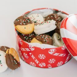 A Christmas tin filled with dipped ritz cookies