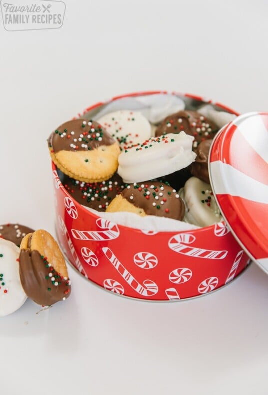 A Christmas tin filled with dipped ritz cookies