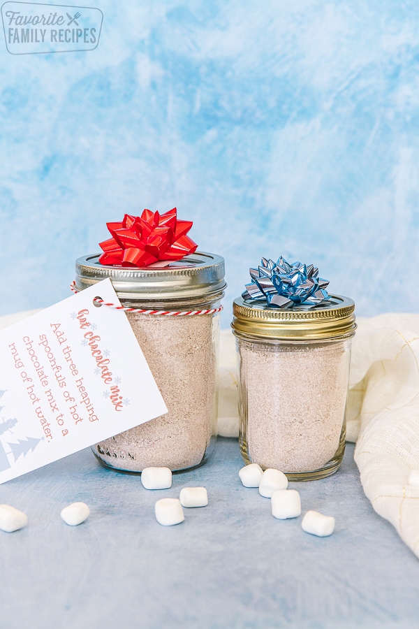 Two jars filled with hot chocolate mix with gift tags attached