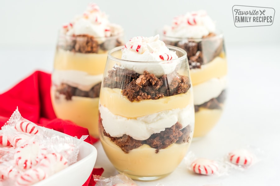 Three peppermint brownie parfaits topped with crushed peppermint