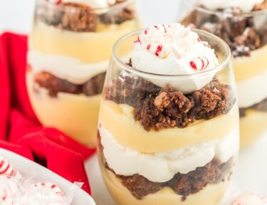 Three Peppermint brownie parfaits topped with crushed peppermint