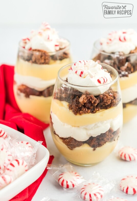 Three Peppermint brownie parfaits topped with crushed peppermint