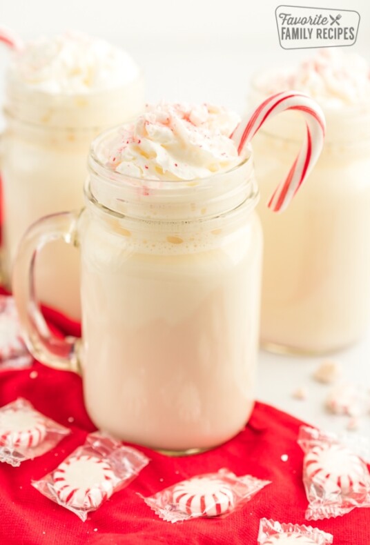 A mug of peppermint hot chocolate with whipped cream and crushed peppermints
