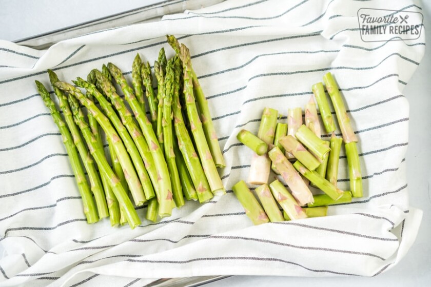 Trimmed asparagus on a dish cloth to make roasted asparagus in the oven