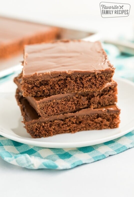 Three pieces of Texas Sheet Cake stacked on a plate