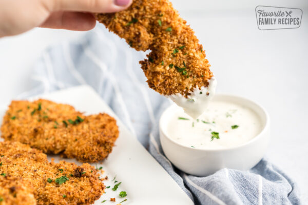 Dipping chicken in ranch sauce