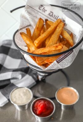 Air Fryer French Fries in a basket with 3 dipping sauces