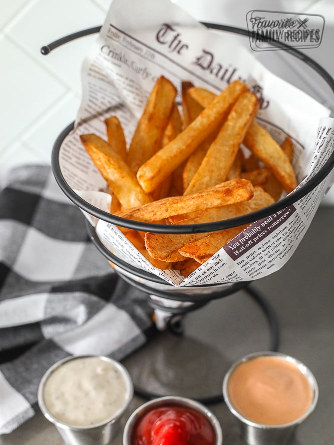 Air Fryer French Fries in a basket with 3 dipping sauces