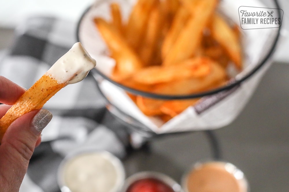 Close up of an air fryer French fry dipped in ranch