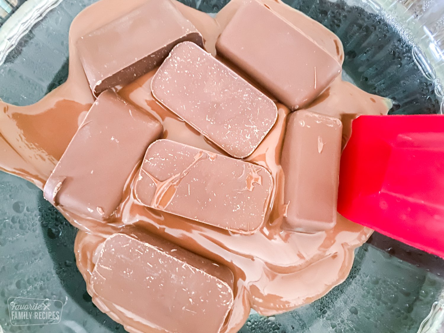 Chocolate being melted in a glass bowl.