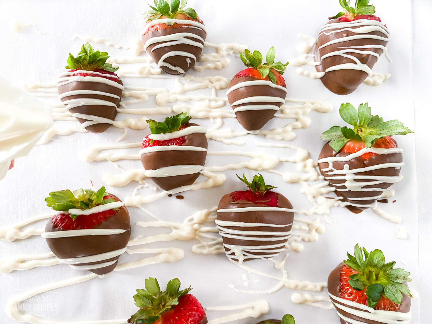 Chocolate covered strawberries on parchment paper.