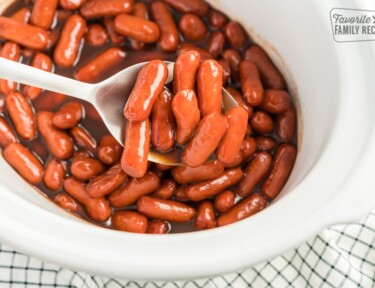 Crock Pot Lil Smokies being scooped up with a spoon