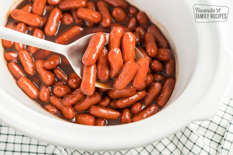 Crock Pot Lil Smokies being scooped up with a spoon