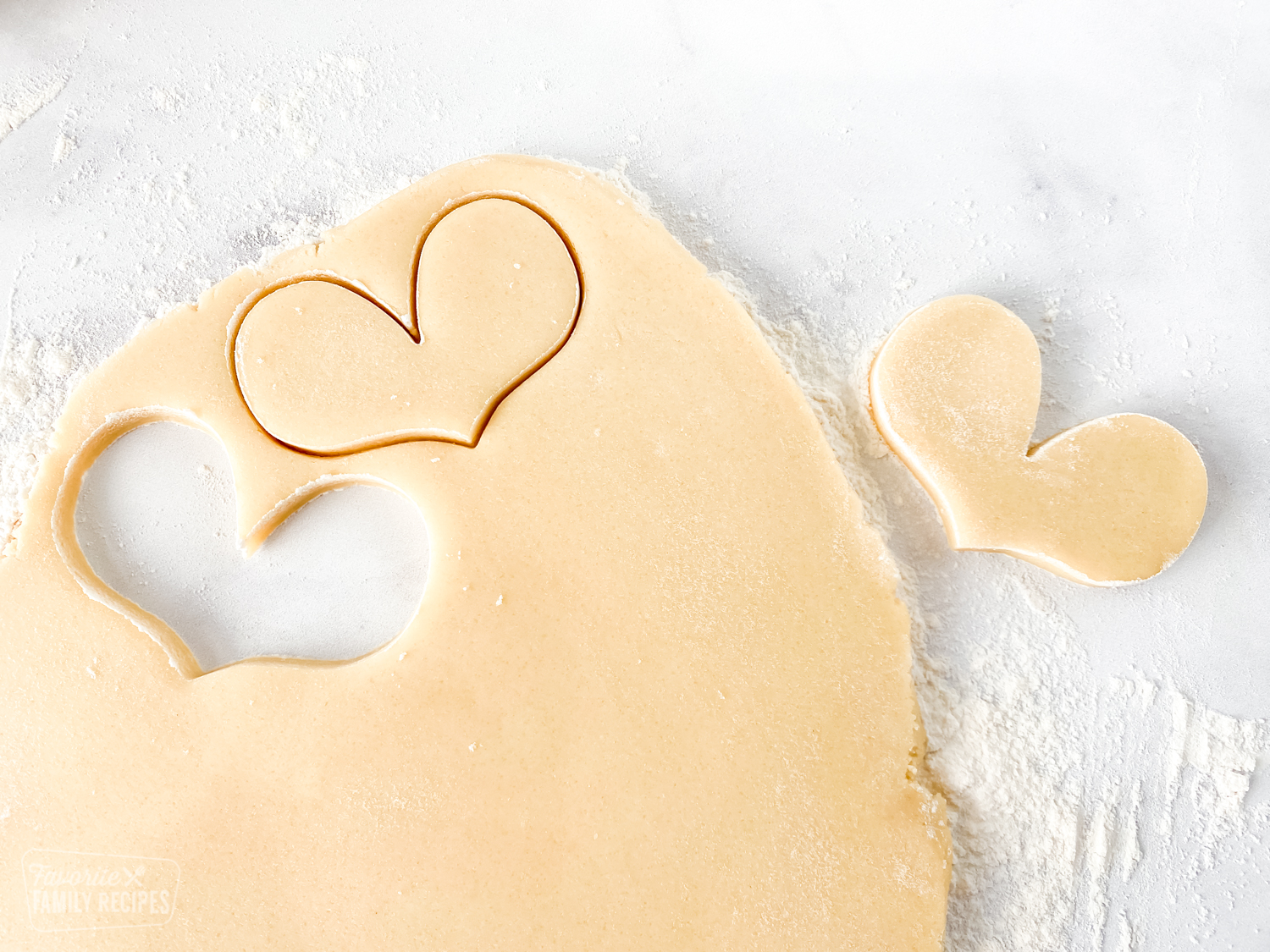 Sugar cookie dough with cut out hearts