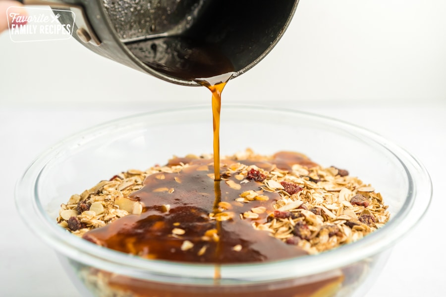 Honey mixture being poured over granola