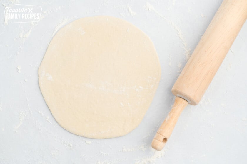 Pizza dough rolled into a circle