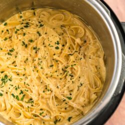 Chicken Alfredo prepared in an Instant Pot with parsley garnish on top