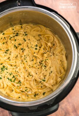 Chicken Alfredo prepared in an Instant Pot with parsley garnish on top