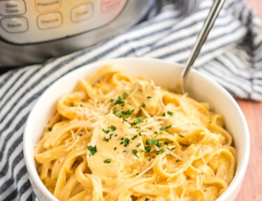 A bowl of Chicken Alfredo with an Instant pot in the background