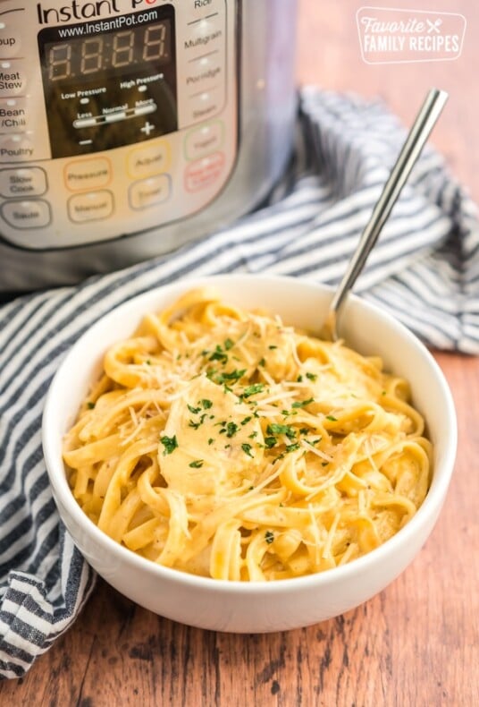 A bowl of Chicken Alfredo with an Instant pot in the background