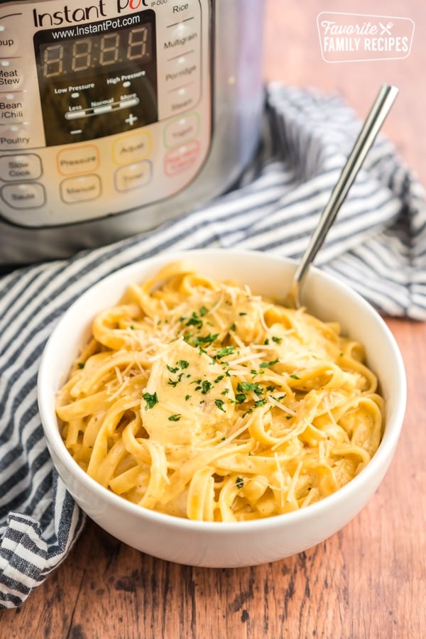 A bowl of Chicken Alfredo with an Instant pot in the background