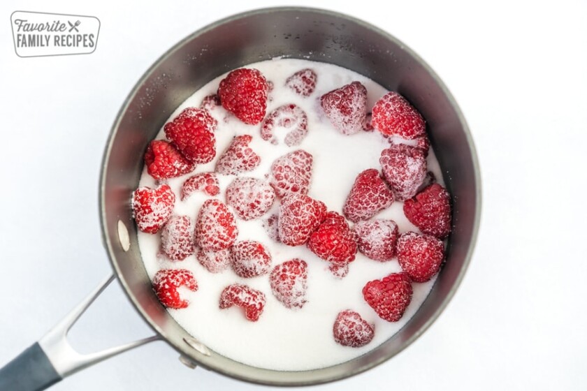 Raspberries and sugar in a sauce pot