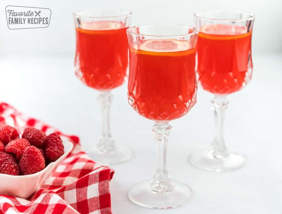 A glass of raspberry cordial topped with lemon slices