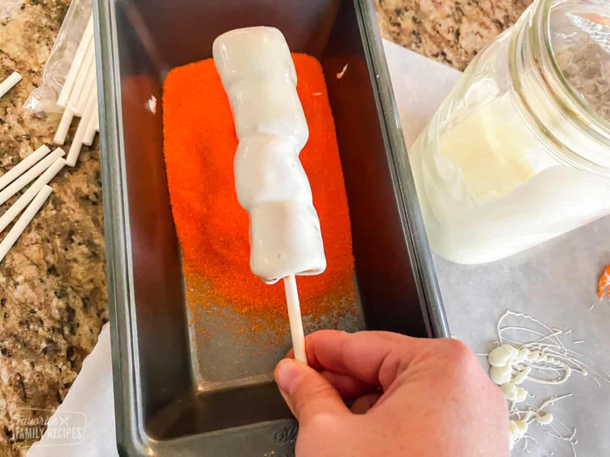 Tigger tail being dipped in sanding sugar