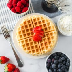 Homemade waffles on a plate with toppings