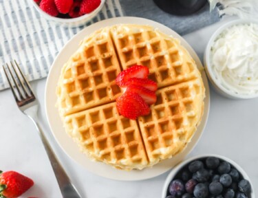 Homemade waffles on a plate with toppings