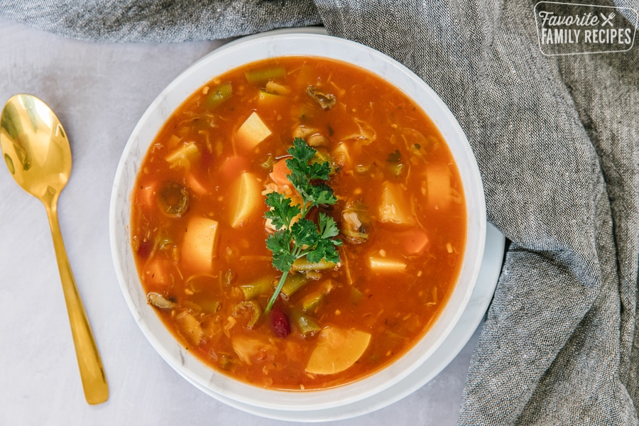 A bowl of Weight loss magic soup with vegetables and parsley