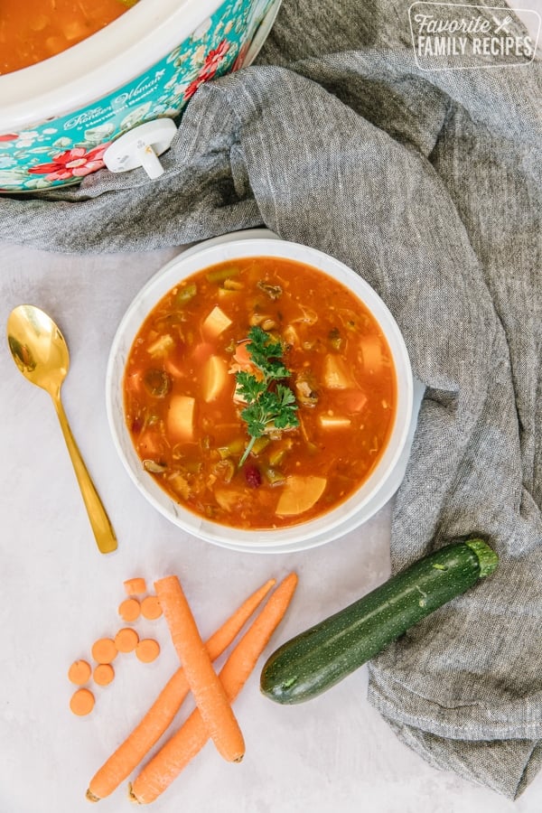 Instant pot weight loss soup in a white bowl with a gold spoon on the side. 