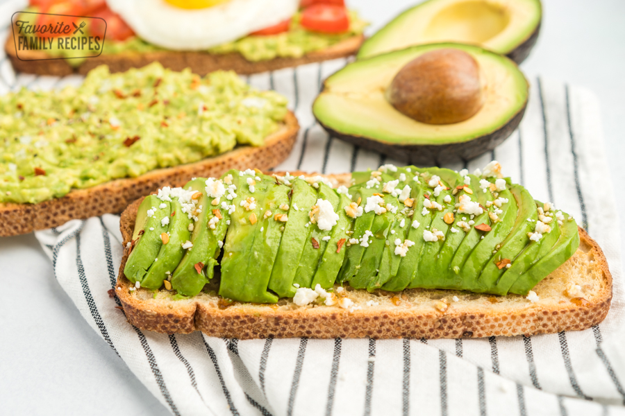 Toast with sliced avocado, feta, honey, and red pepper flakes