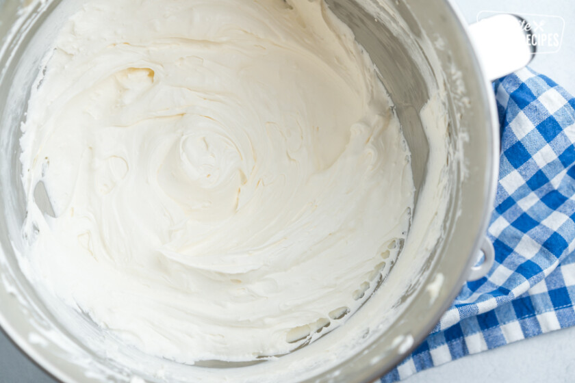 Cream cheese cool whip topping in a metal mixing bowl