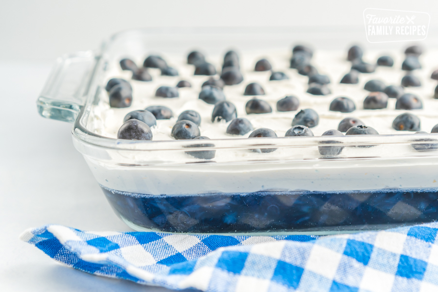 Blueberry Jello Salad topped with fresh blueberries in a glass baking dish