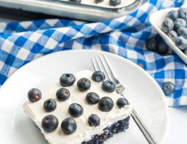 Blueberry Jello Salad topped with fresh blueberries in a glass baking dish